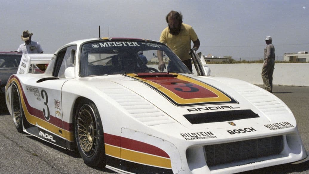 The wrap references the ANDIAL 935-L's racing livery — white base, red-yellow-orange stripe, "3" roundel.